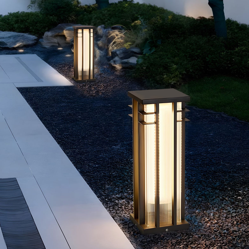 Modern landscape design enhanced by strategically placed column lights illuminating garden pathways at dusk