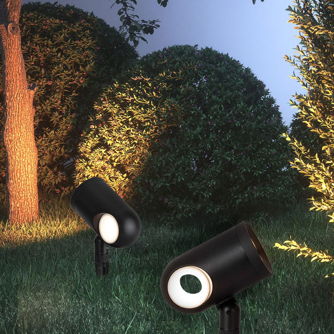 Landscape hedge lighting using a waterproof spotlight to create warm evening illumination.