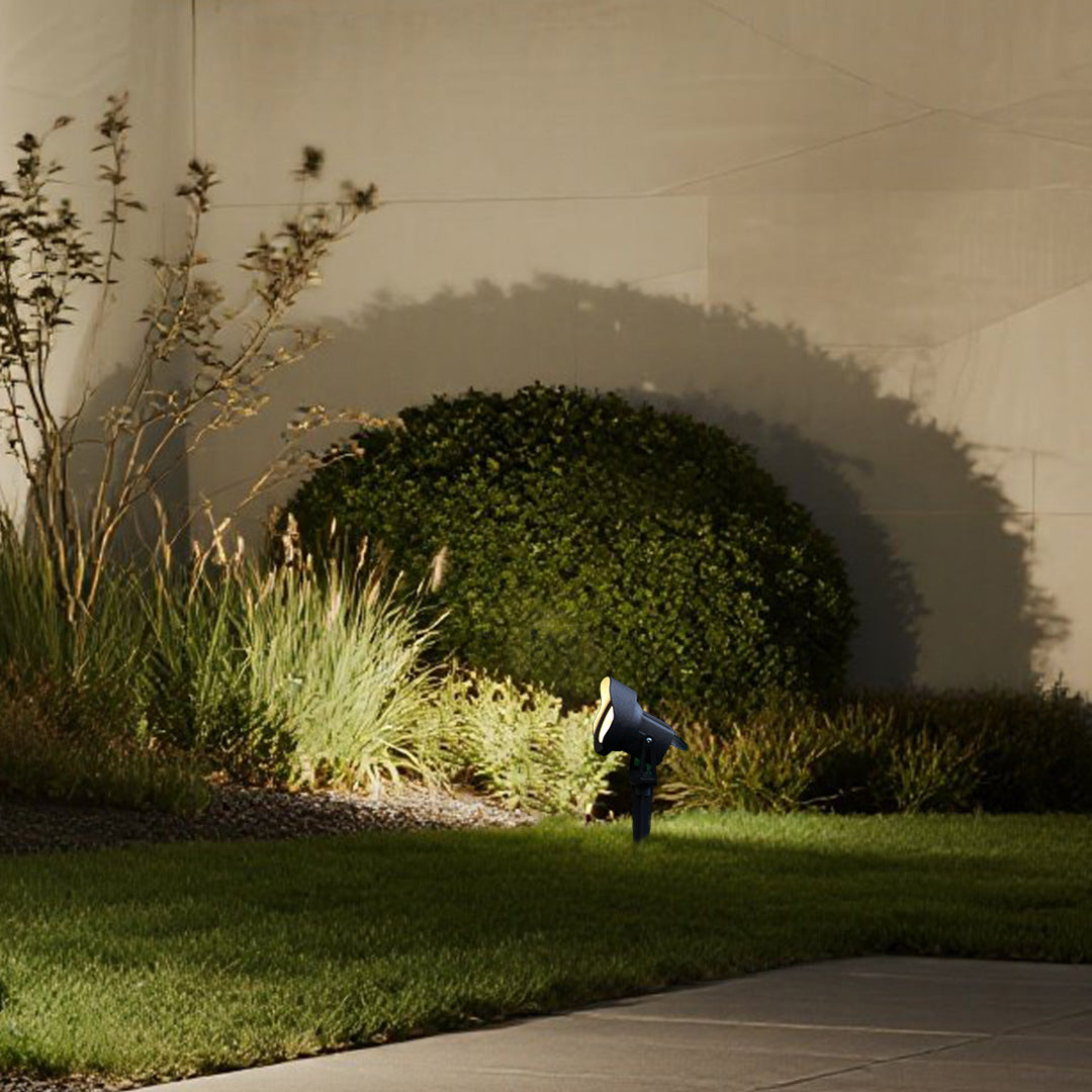 Sophisticated landscape lighting highlighting mature trees against modern building facade at night