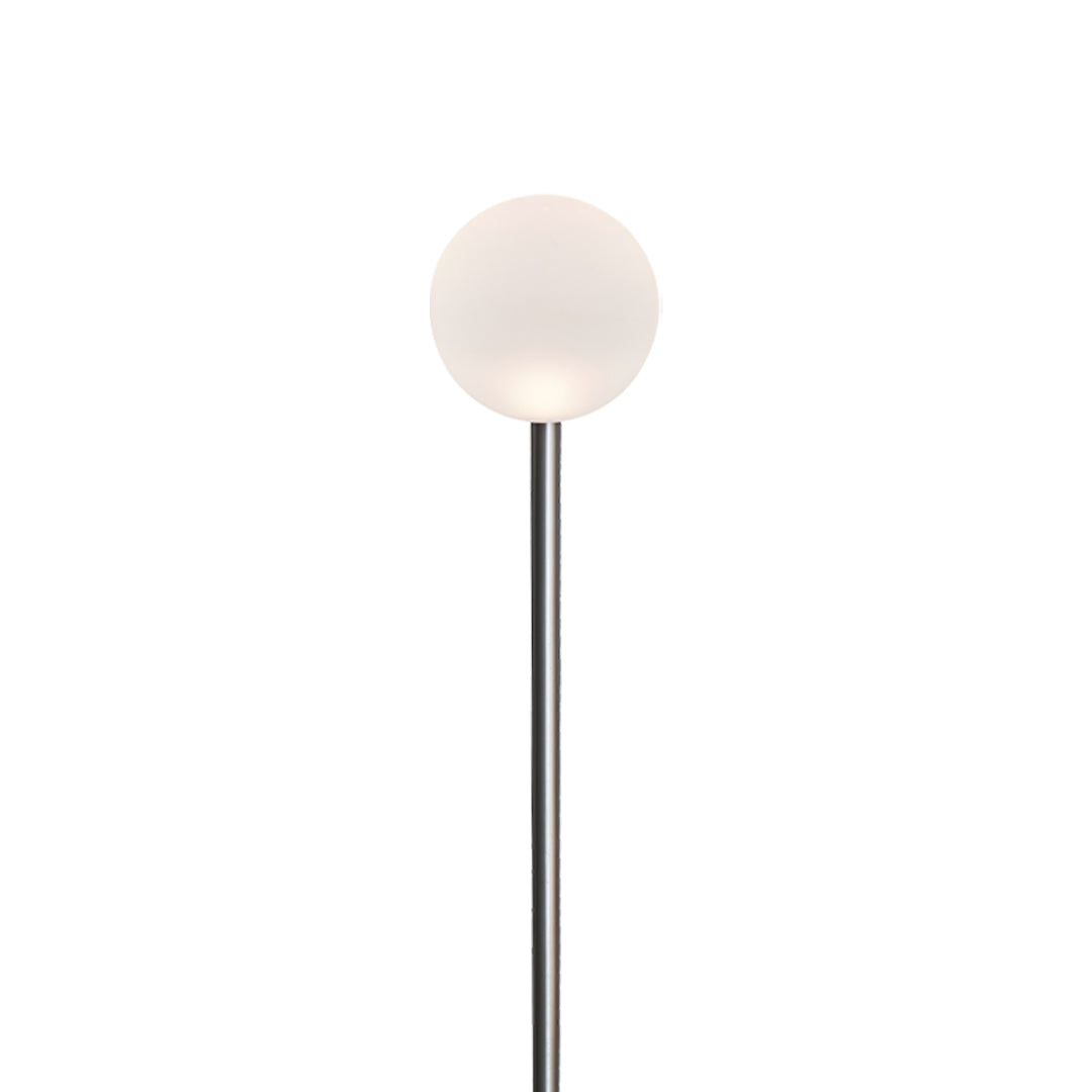 A glowing outdoor globe light on a slim vertical pole, designed to add gentle brightness along a landscape lighting pathway.