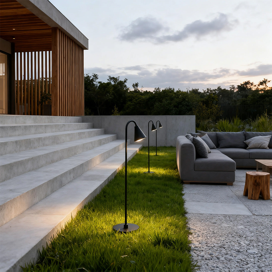 Landscape path light along a gravel pathway, providing subtle and elegant illumination.