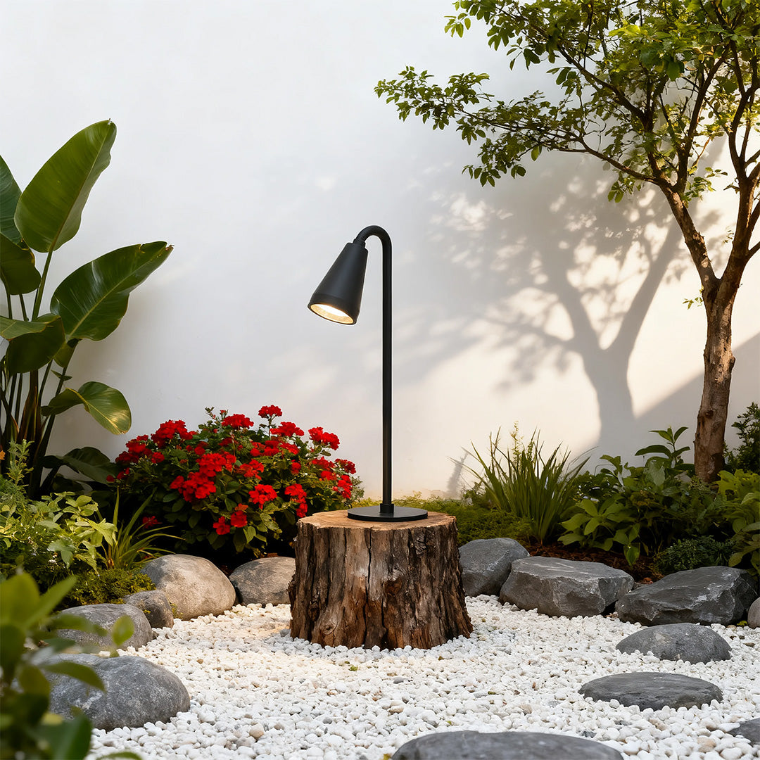Landscape path light along a modern building's pathway, offering a stylish and functional lighting solution.