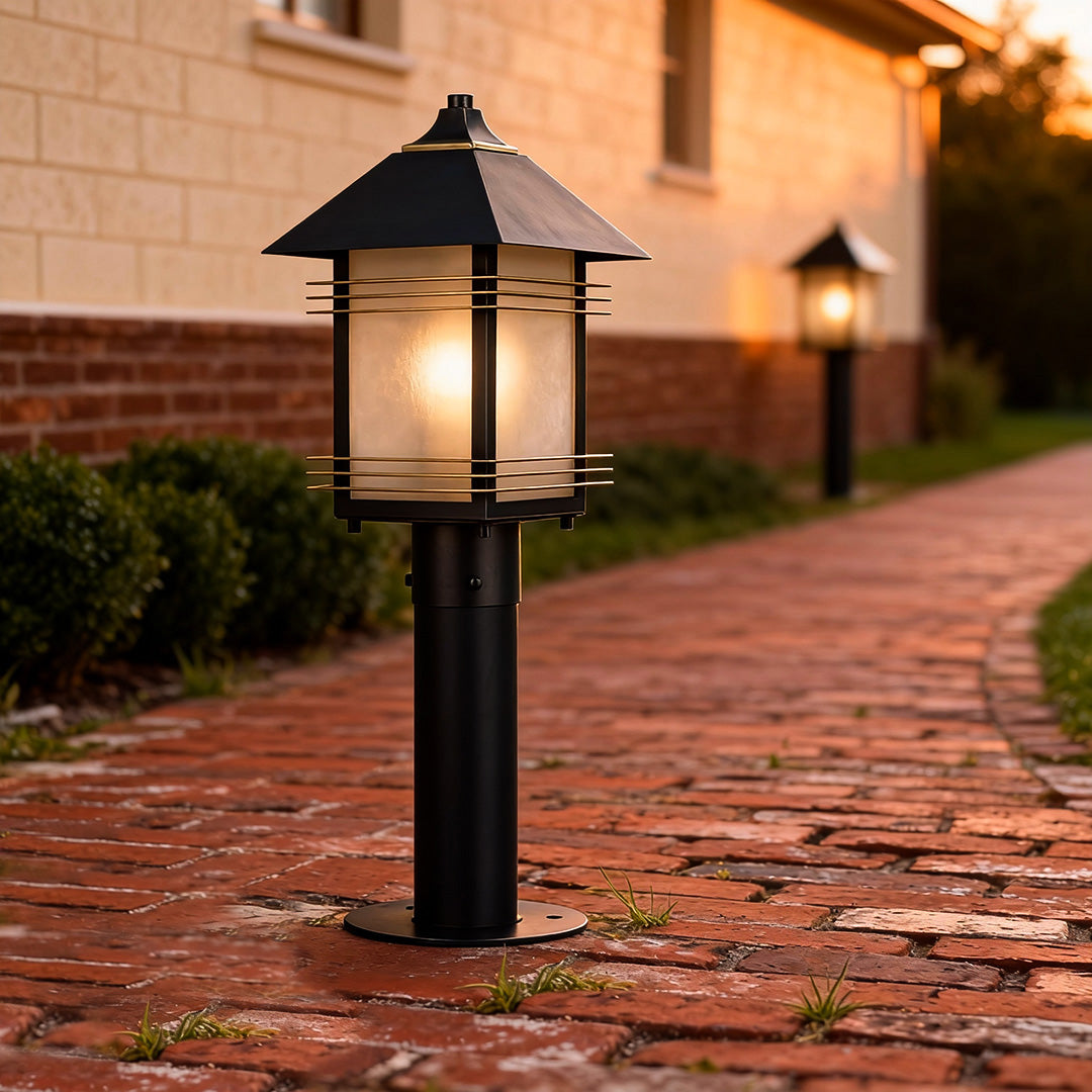 Landscape path lighting fixtures lining a brick walkway, adding classic style and functional lighting to an outdoor pathway.