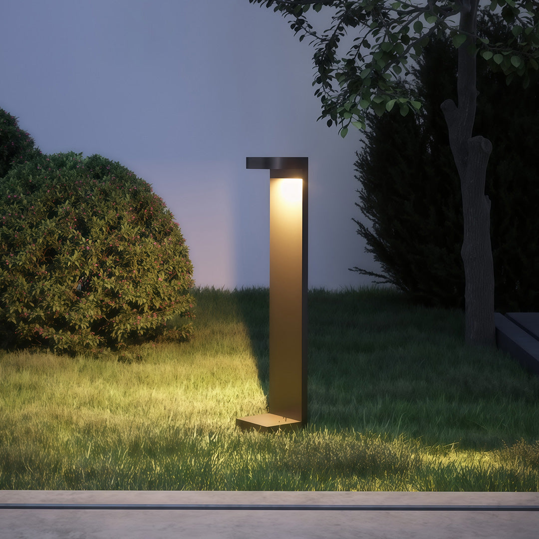 Landscape pathway light along a modern building's pathway, offering stylish and functional lighting.