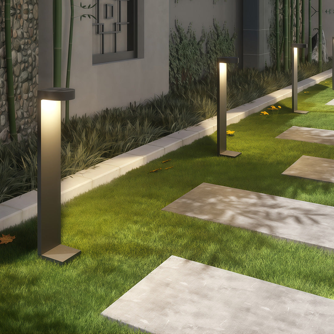 Landscape pathway light illuminating a set of outdoor steps, providing safety and aesthetic appeal.