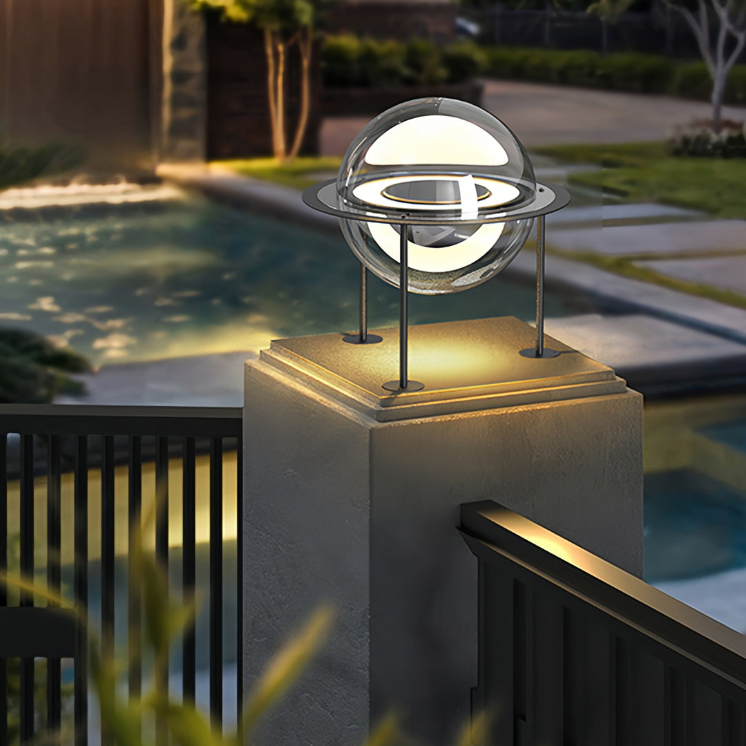 Modern landscape featuring circular ring main gate pillar light design illuminating pathway and exterior walls.