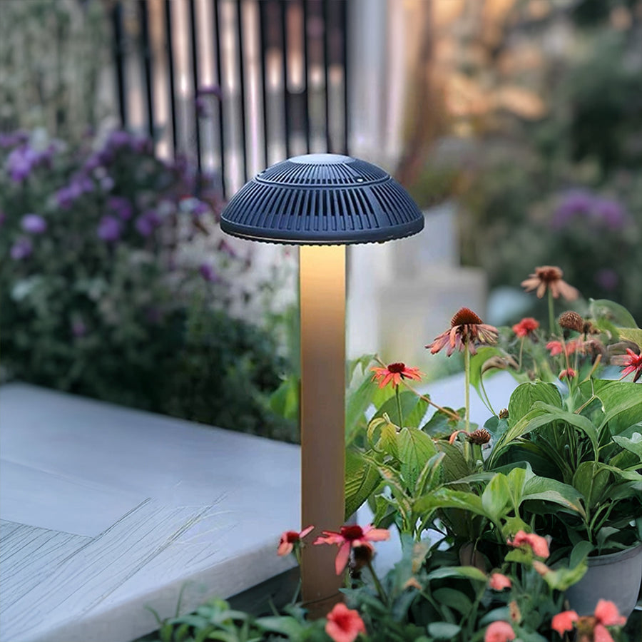 Modern bollard lights installed in landscaped garden creating elegant outdoor lighting design