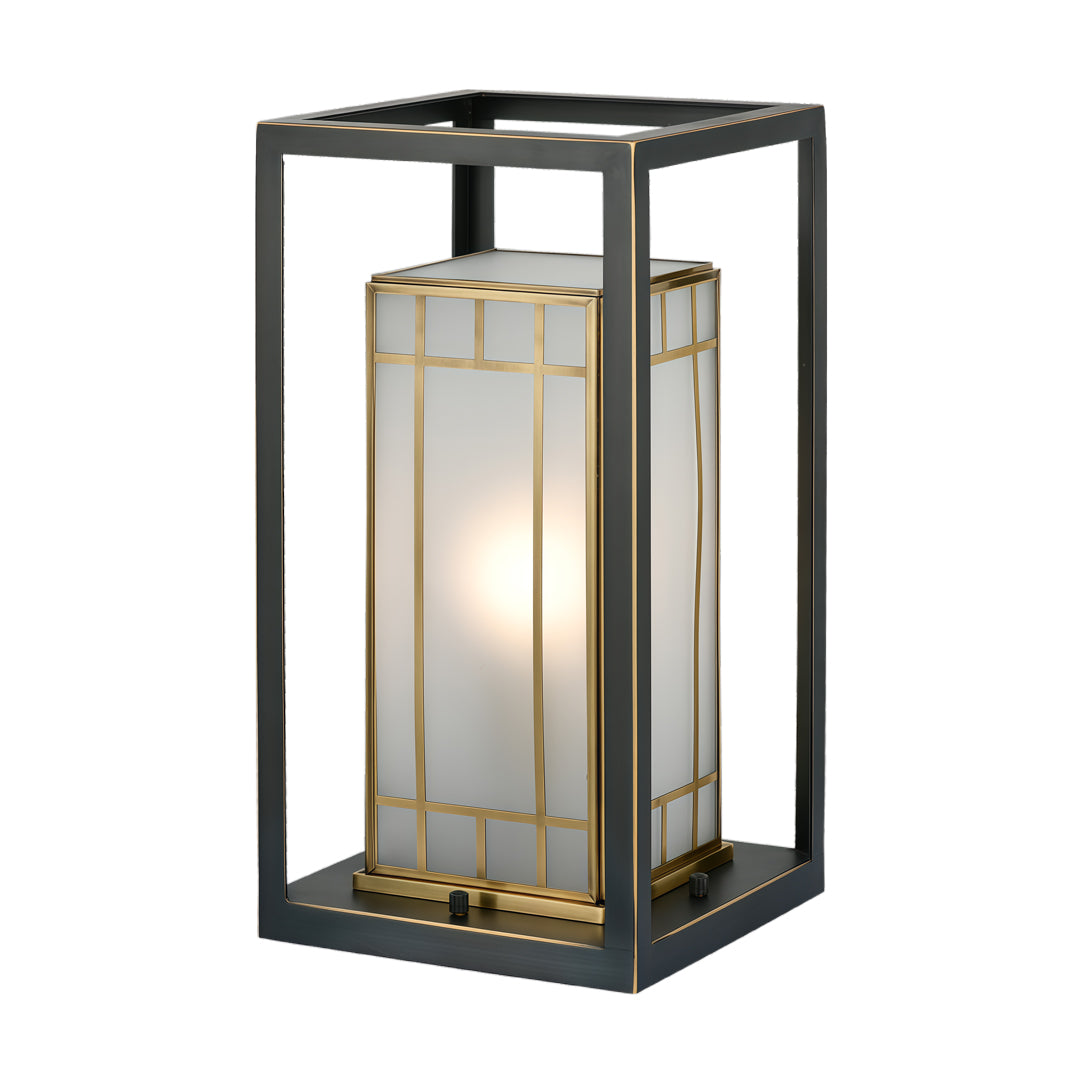 Modern lantern bollard light featuring clear panels and a soft warm light source, designed for contemporary outdoor spaces.