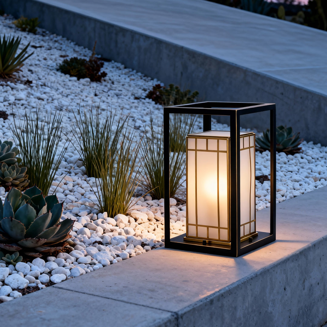 Lantern bollard light illuminating a modern walkway edge, blending architectural style with functional outdoor lighting.