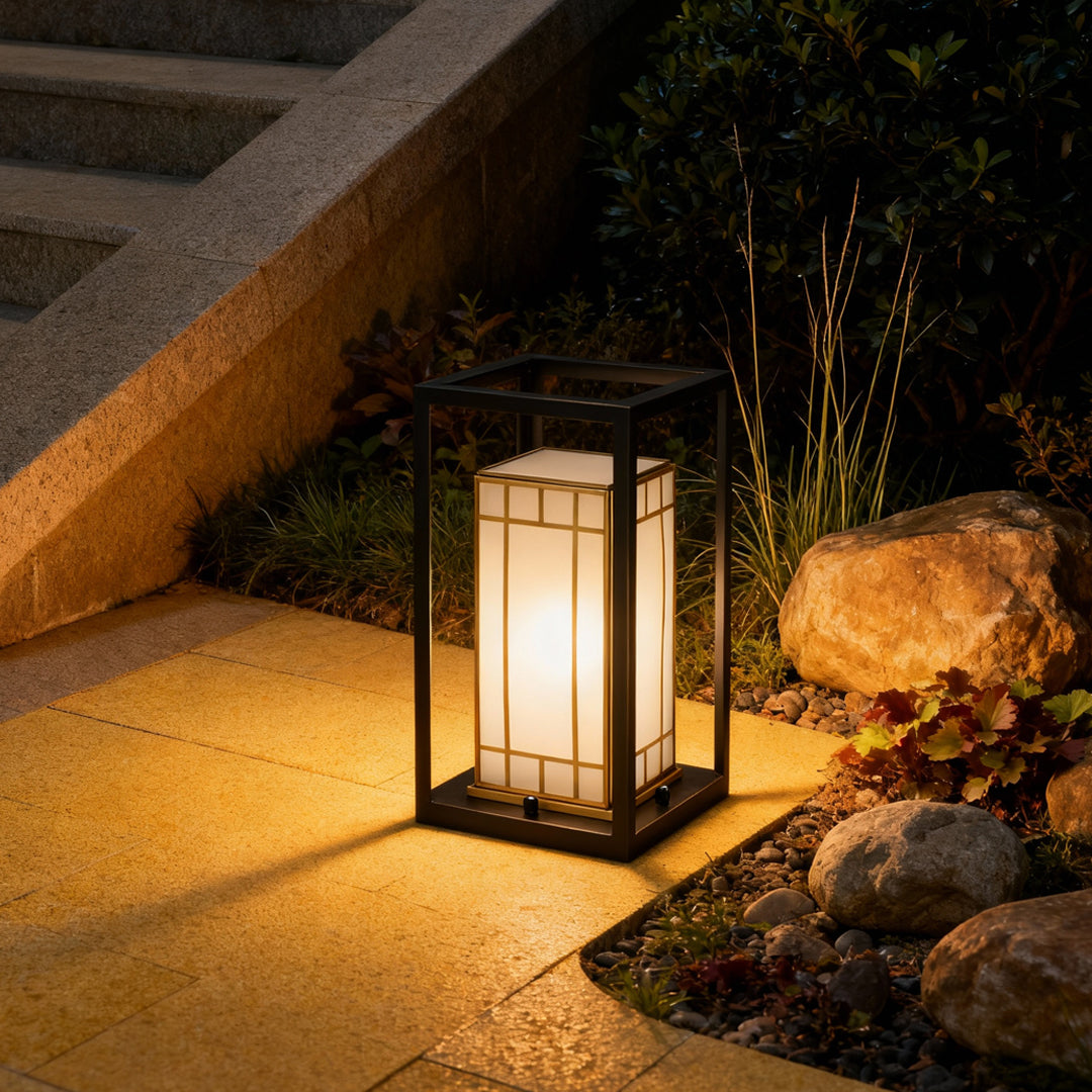 Outdoor lantern bollard light placed beside steps and landscaping, creating safe and elegant pathway lighting at night.