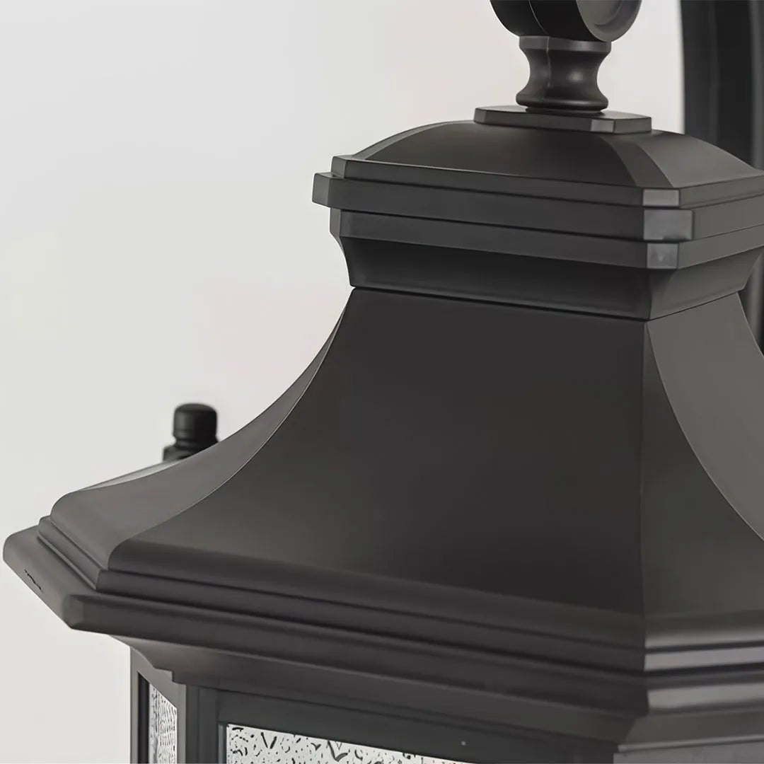 Lantern outdoor wall lights close-up showing the decorative black metal top and classic fixture profile.