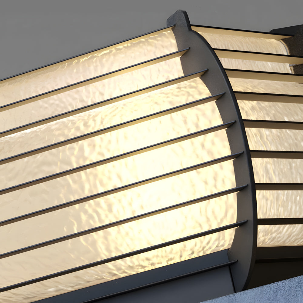 Close-up detail of lantern pillar lights showing layered shade design and soft diffused LED illumination.