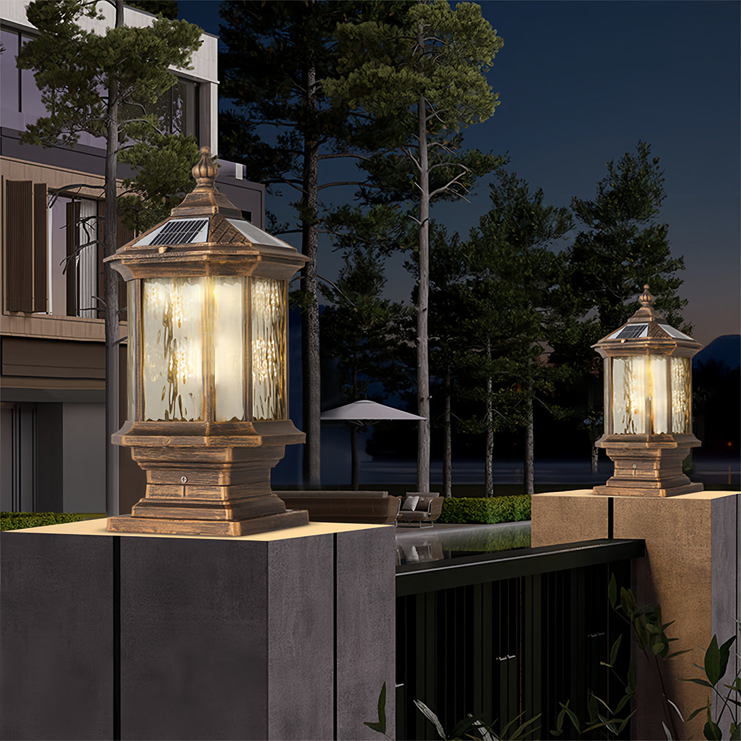 Lantern pillar lights near a modern house, adding a classic touch to the outdoor decor.