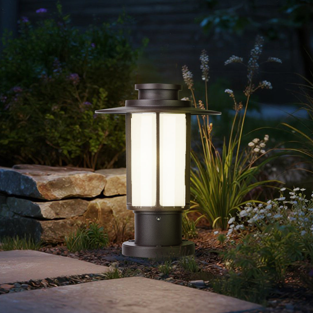 Classic outdoor lantern post lights lining a landscaped garden path at dusk
