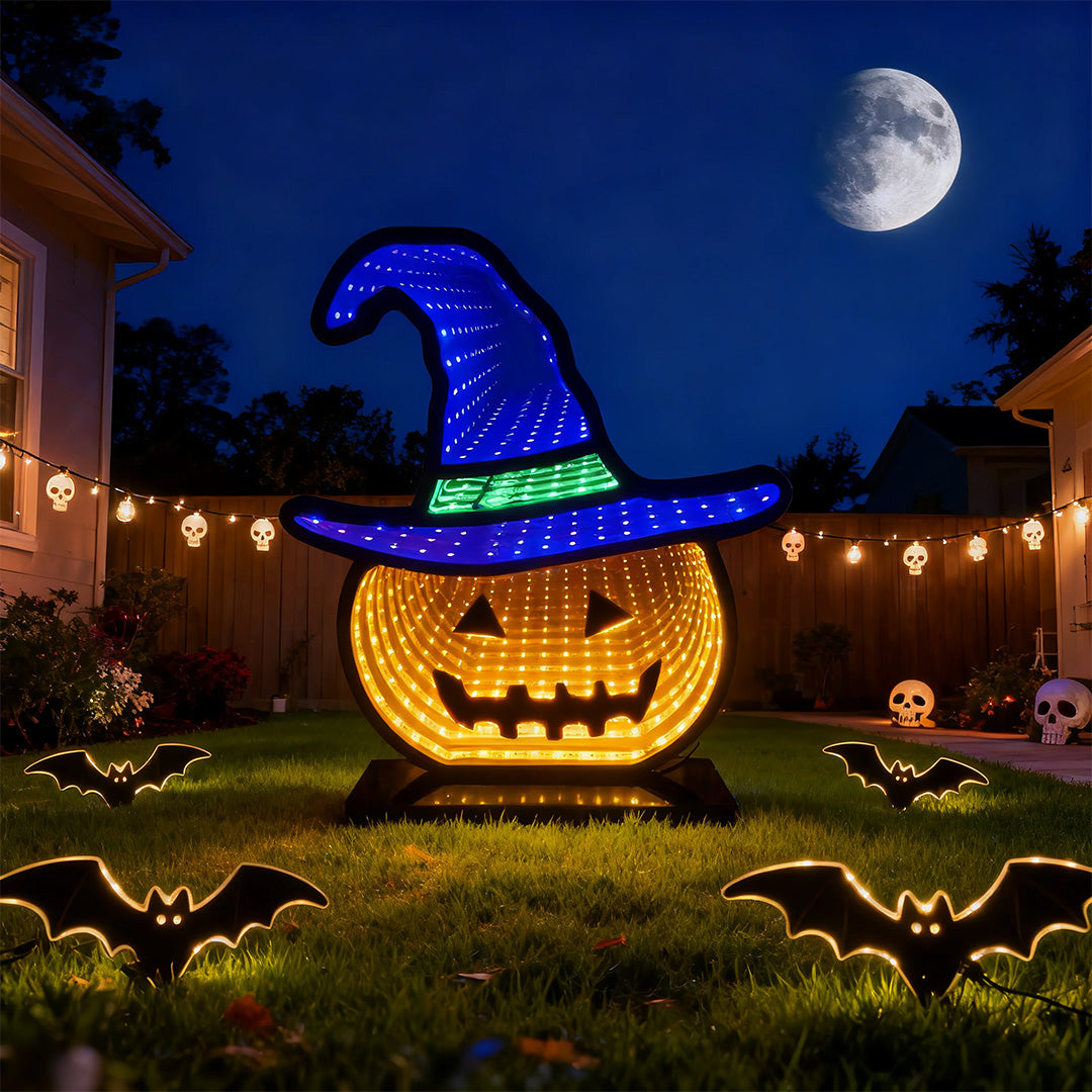 Large backlit halloween pumpkin lights yard stake display at night under the full moon and flying bats.