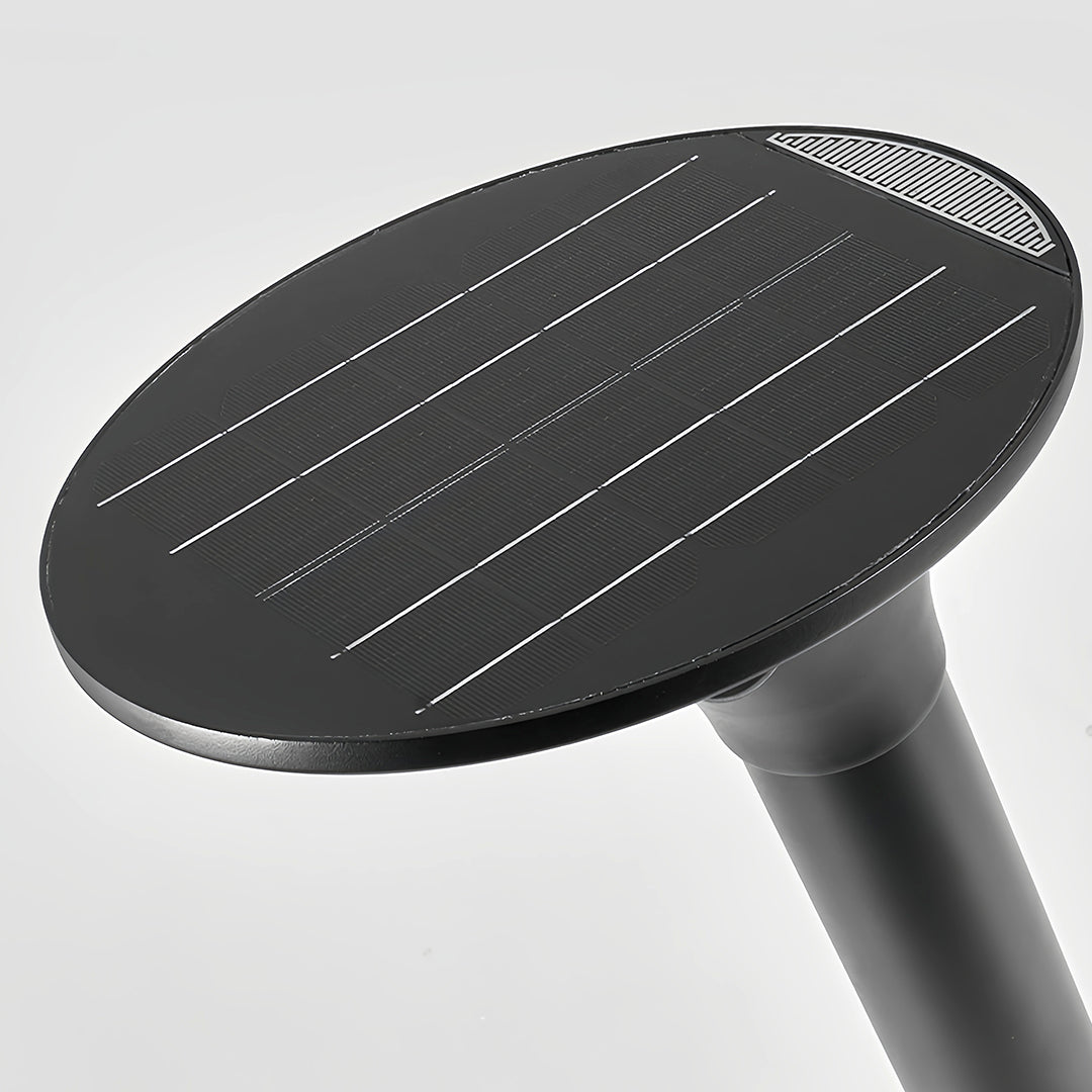 Close-up of the large circular integrated solar panel on the top cap of the modern black solar bollard lights.