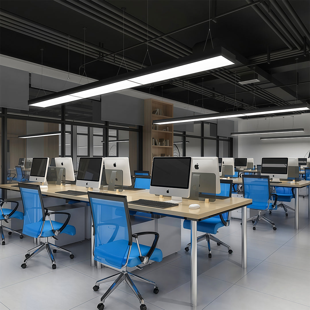 Large conference room illuminated by a long rectangular chandelier, offering bright and contemporary lighting.