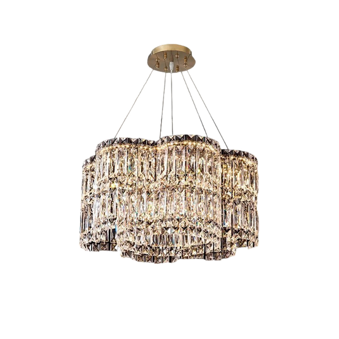Large crystal chandelier with a gold frame, featuring a curved and elegant design.