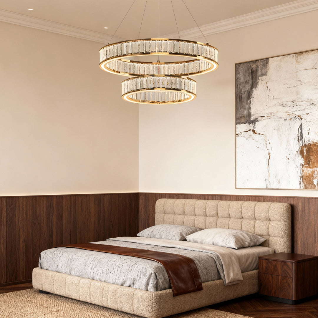 Large crystal chandeliers suspended above bed in luxurious bedroom with dark wood paneling and neutral color scheme