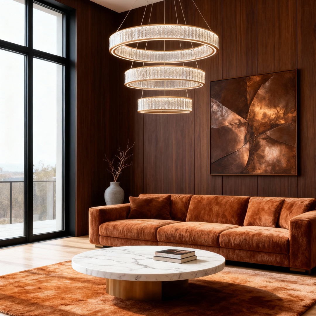 Large crystal chandeliers creating focal point in modern living room with cognac leather sofa and dramatic artwork