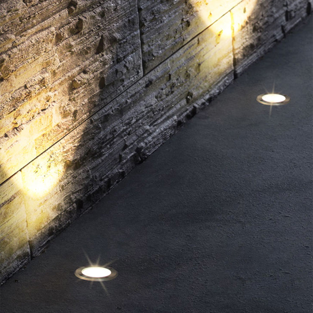 Compact round in-ground fixture with LED array and weather-resistant design for pathway illumination