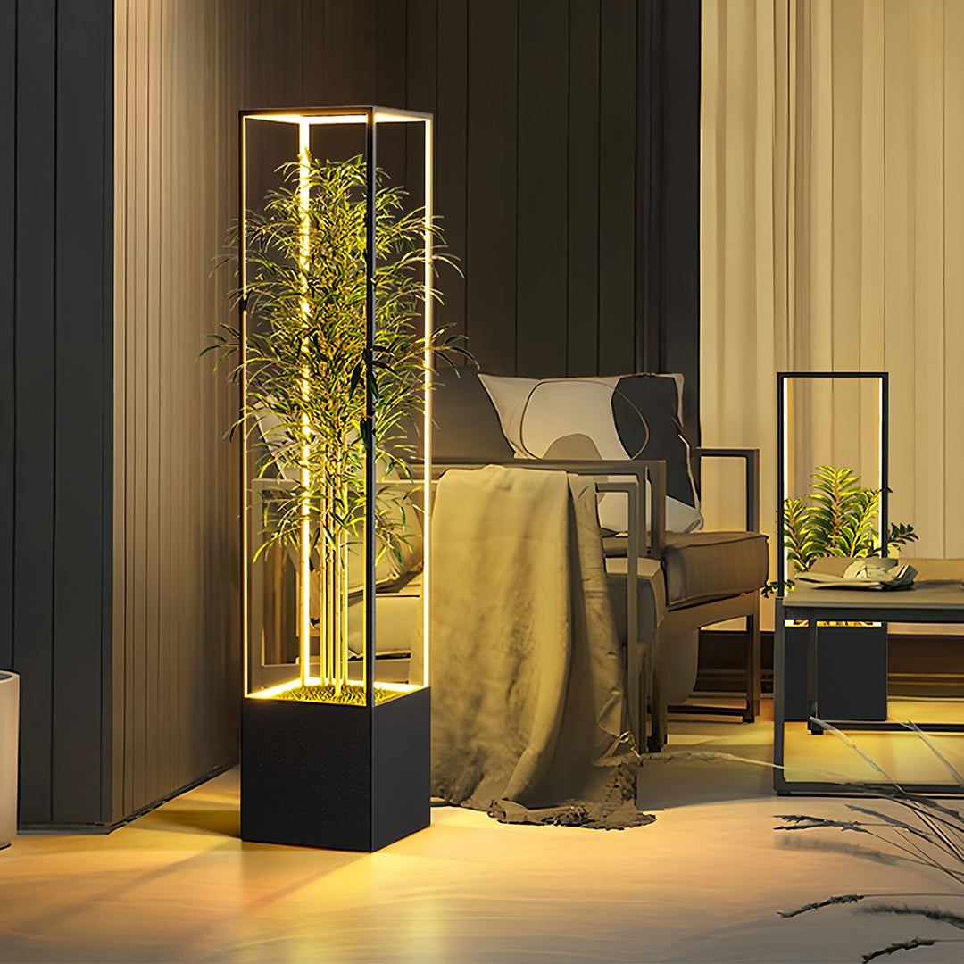 Large decorative square floor lamps used as ambient lighting in an exterior lounge area, providing a warm glow around a seating arrangement.