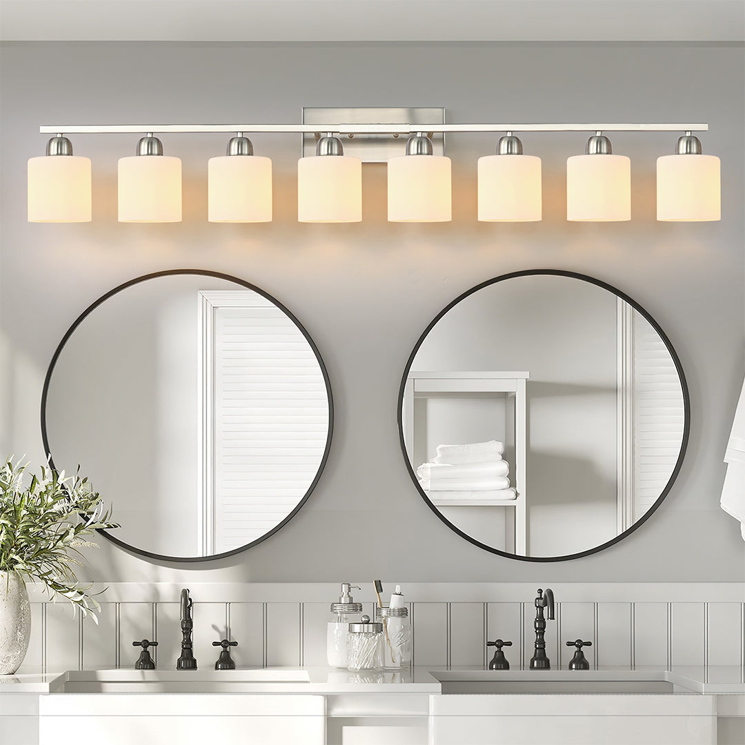 Modern bathroom vanity light with three bulbs, installed above a large mirror in a contemporary bathroom.