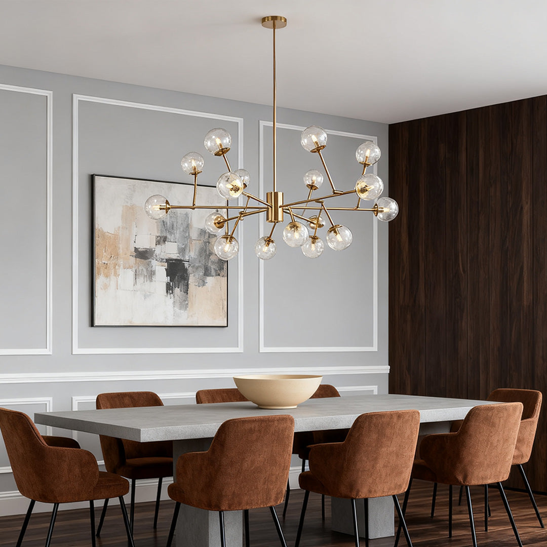 Large, modern bubble sputnik chandelier with frosted globes, suspended over a dark wood dining table next to a brightly lit window.