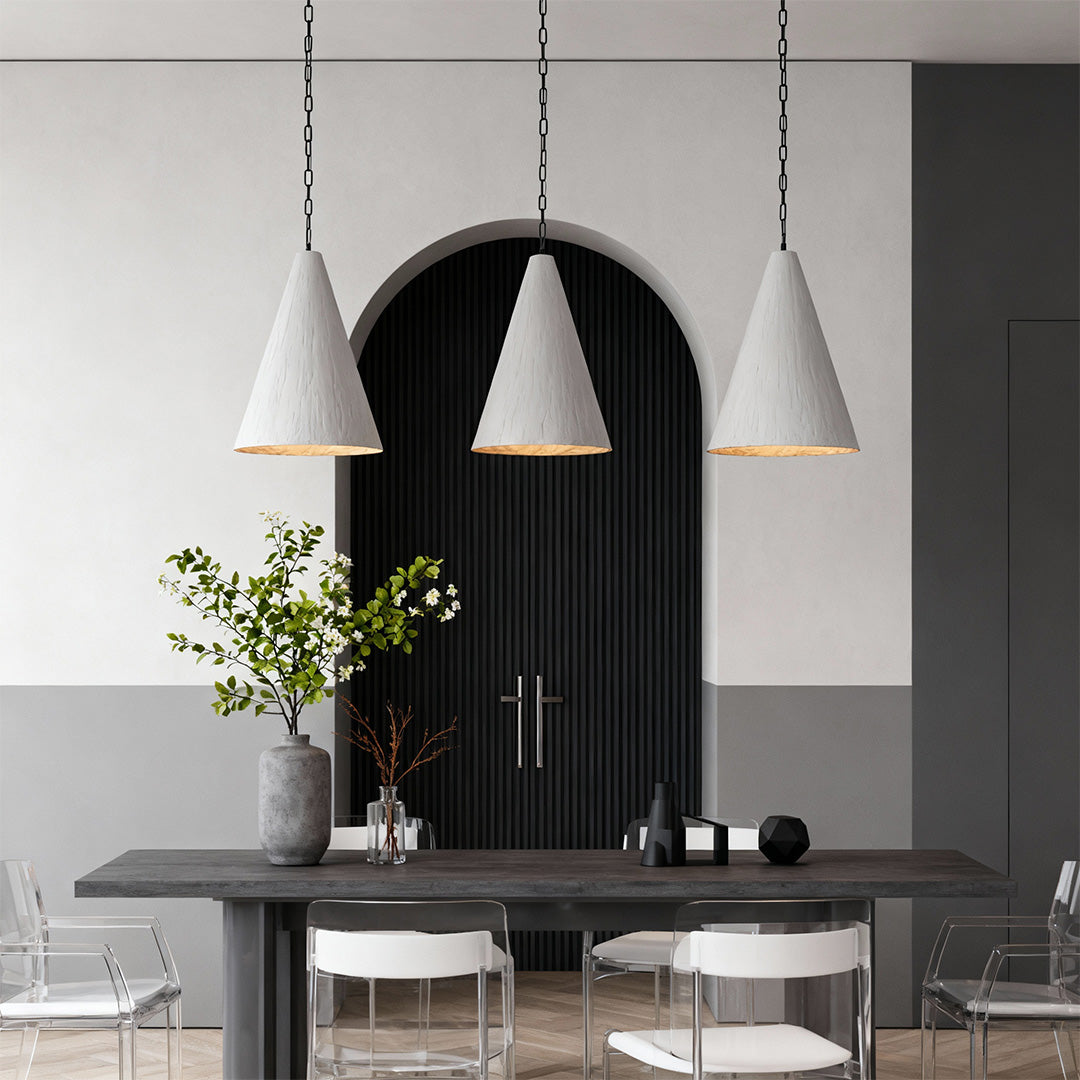 Set of large Nordic style pendant lights suspended in modern interior with arched wall decor.