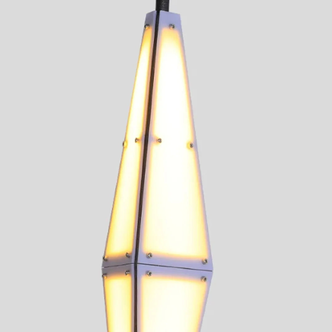 Close-up of large outdoor sconces featuring a tall diamond-inspired shape and warm internal glow.