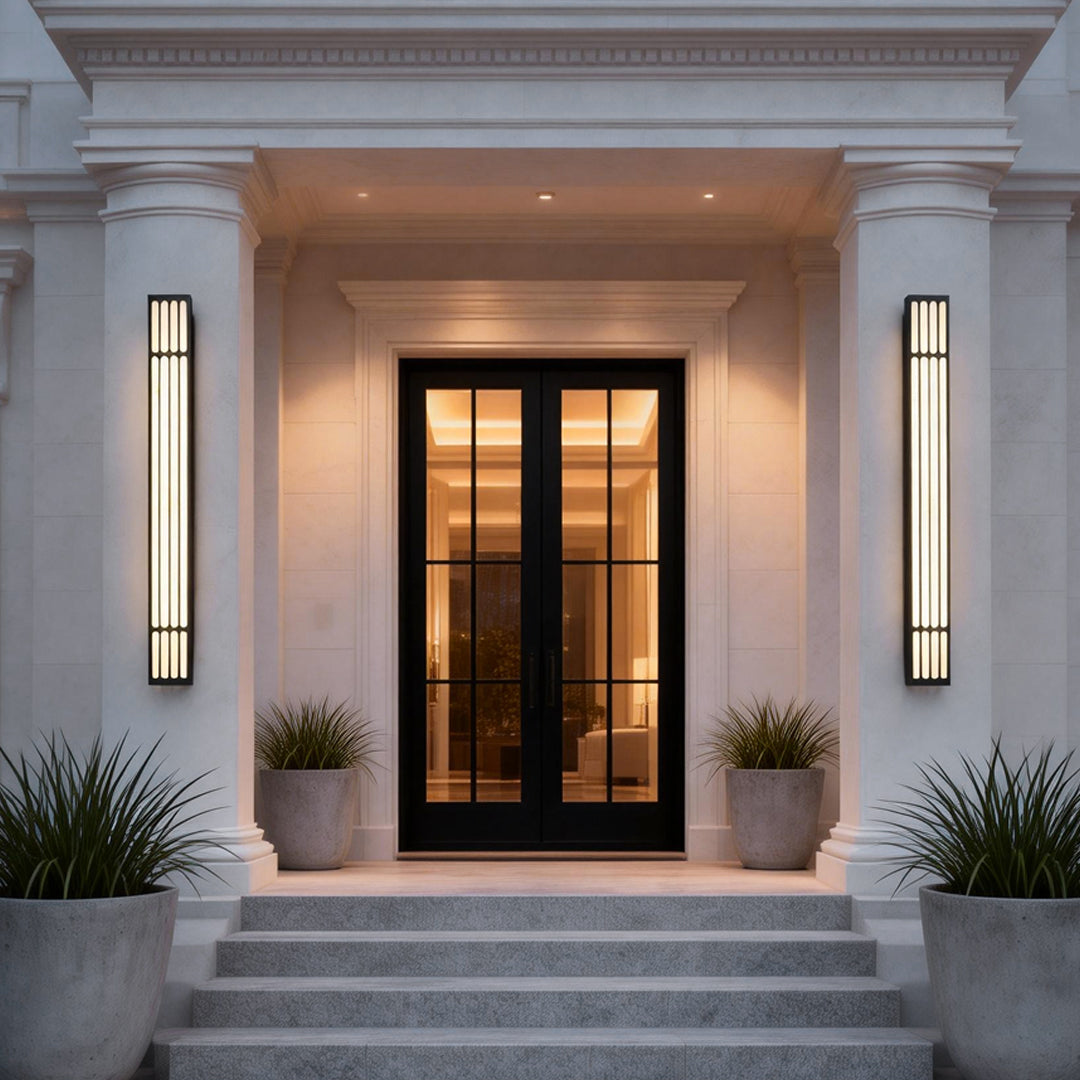 Large outdoor wall light illuminating a classic house entrance with warm, elegant glow.