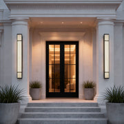 Large outdoor wall light illuminating a classic house entrance with warm, elegant glow.