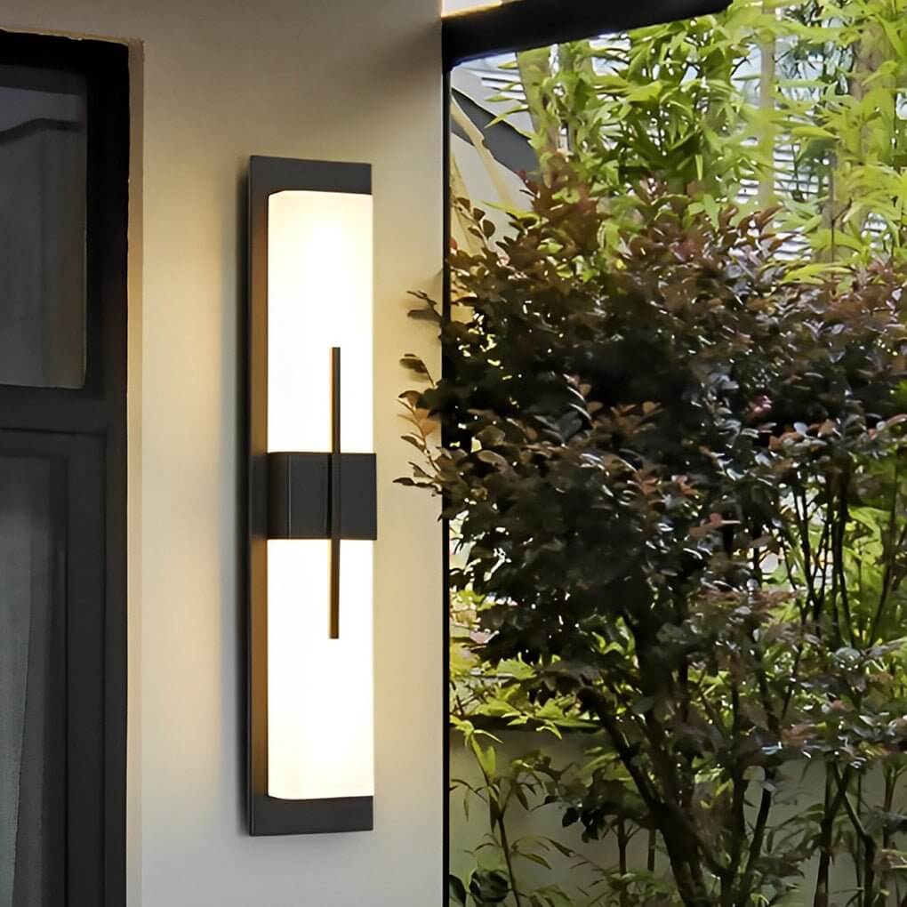 Large outdoor wall light fixture with vertical light bars, illuminating a modern building facade.