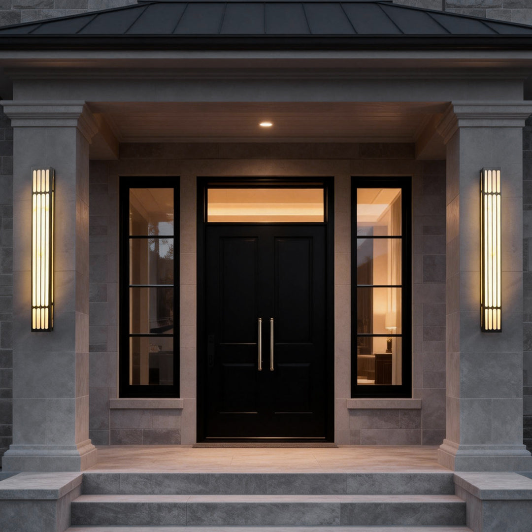 Large outdoor wall light providing soft illumination beside a modern black door.