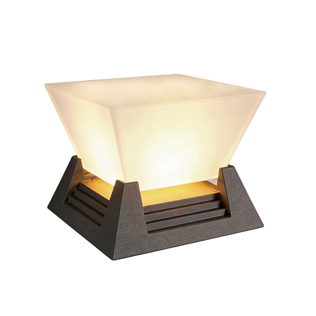 Modern large pillar light with a geometric design and warm yellow illumination.