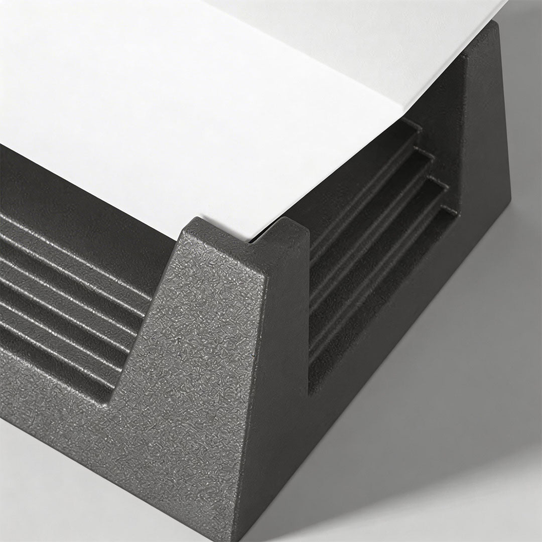 Close-up of a large pillar light with a sleek black design and illuminated top.