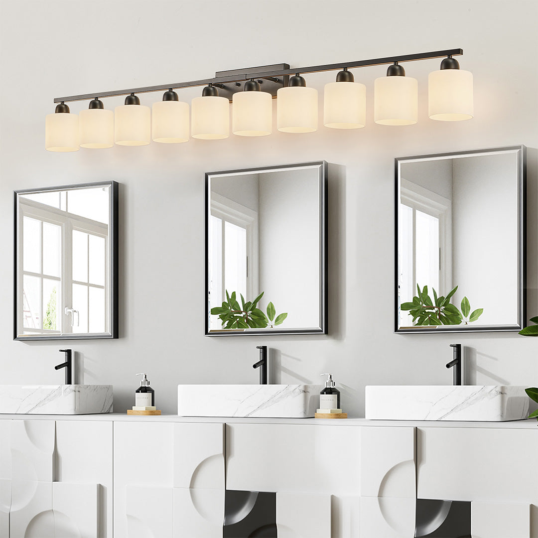 Modern bathroom vanity light with three bulbs, installed above a large rectangular mirror in a stylish bathroom.