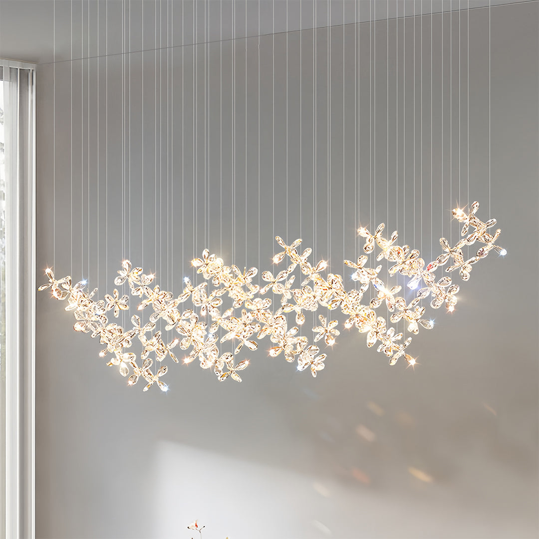 Large rock crystal chandelier with organic branch design illuminating contemporary dining space