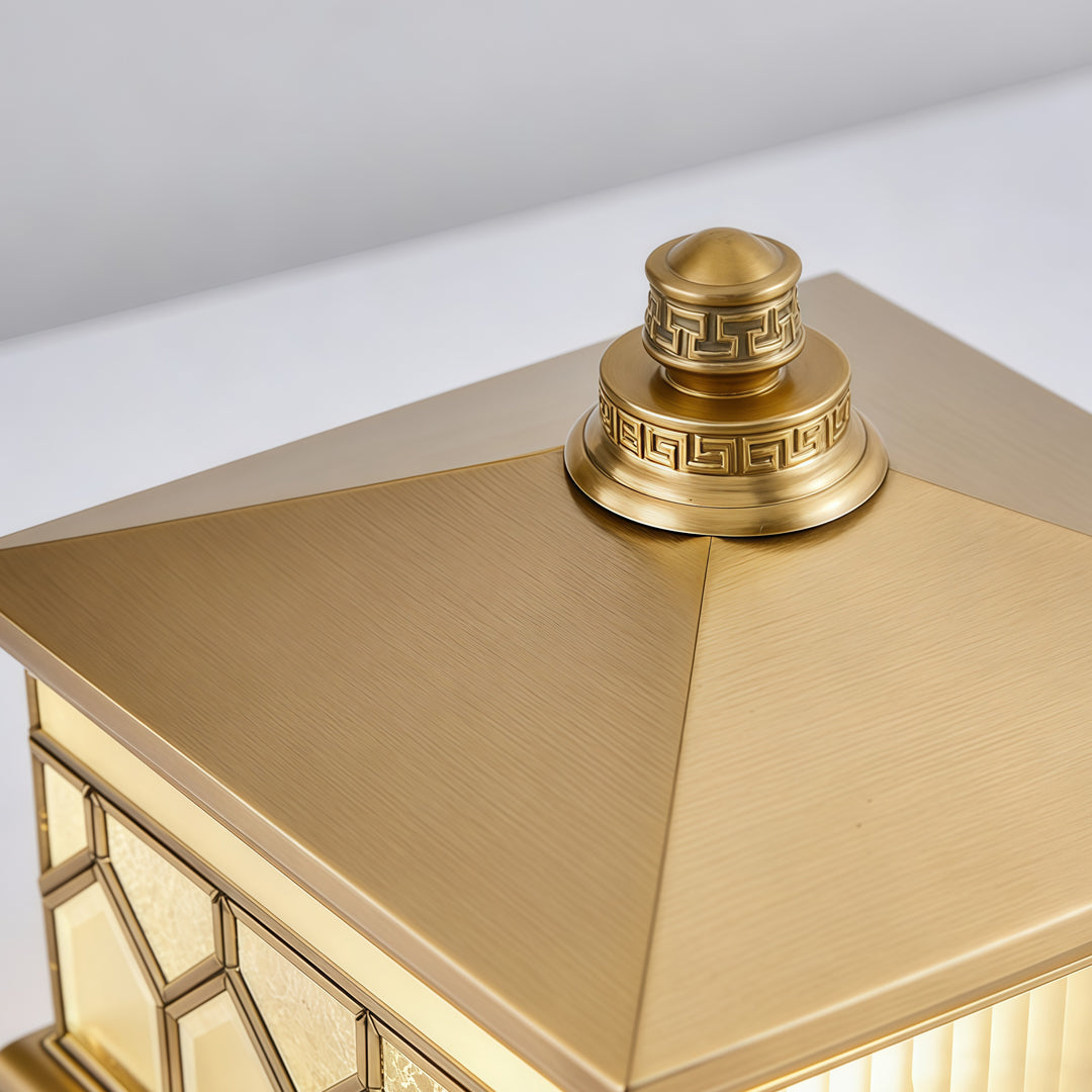 Large solar pillar lights close-up of decorative metallic top with luxury outdoor lantern detailing.