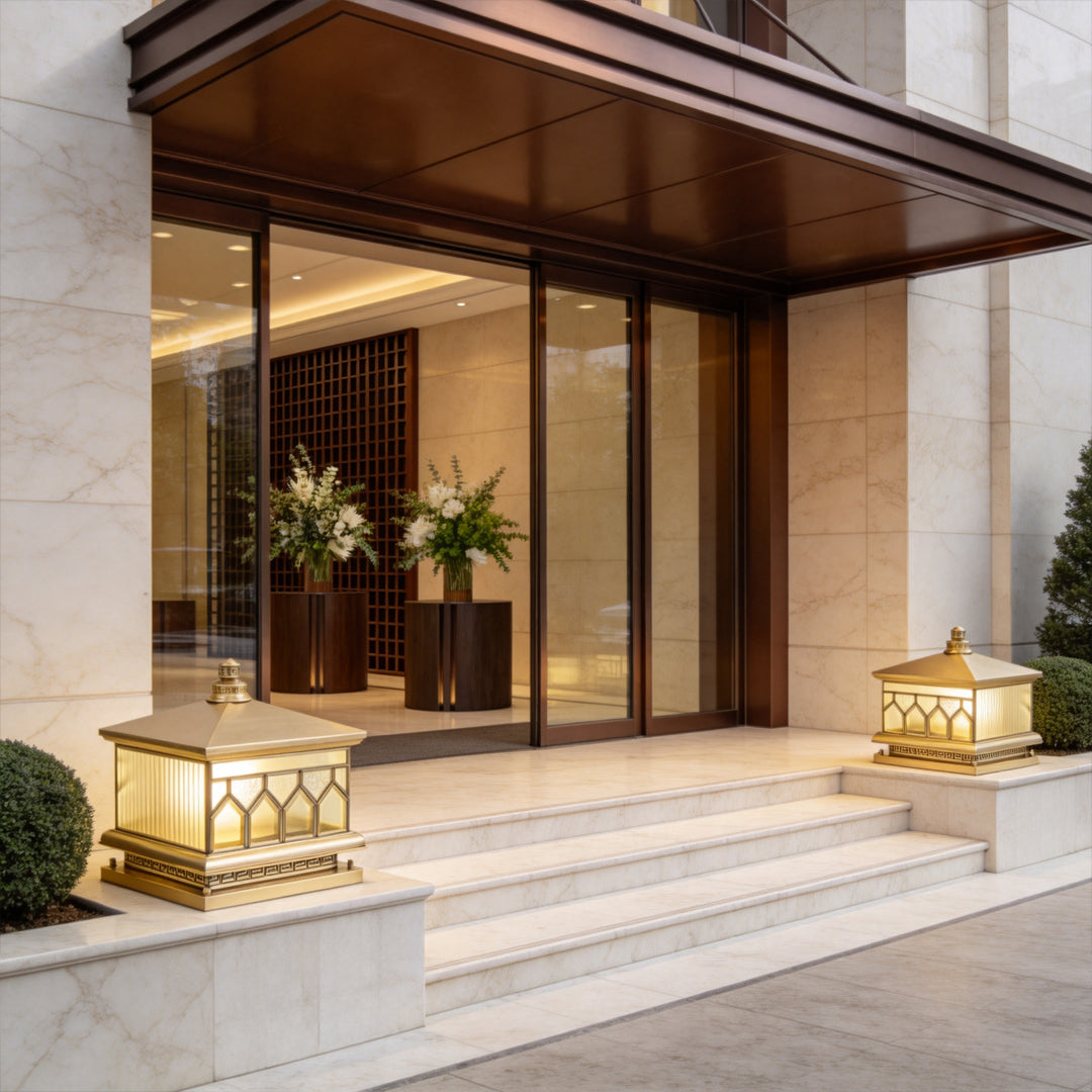 Large solar pillar lights installed beside modern exterior stairs with elegant warm lighting effects.