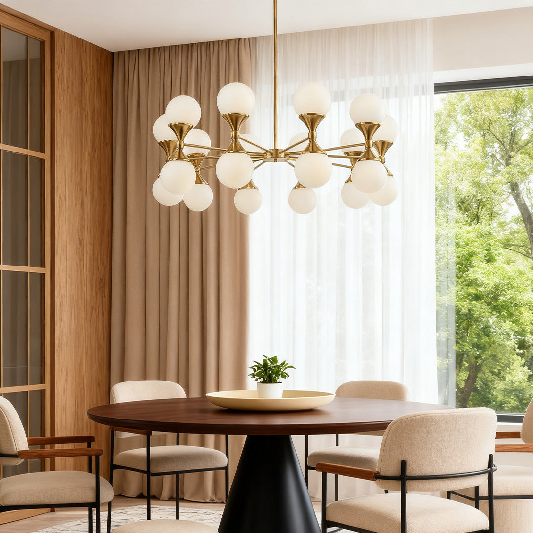 Large Sputnik-style bubble glass chandeliers featuring multiple frosted globes, suspended over a dark wood dining table near a grand staircase.