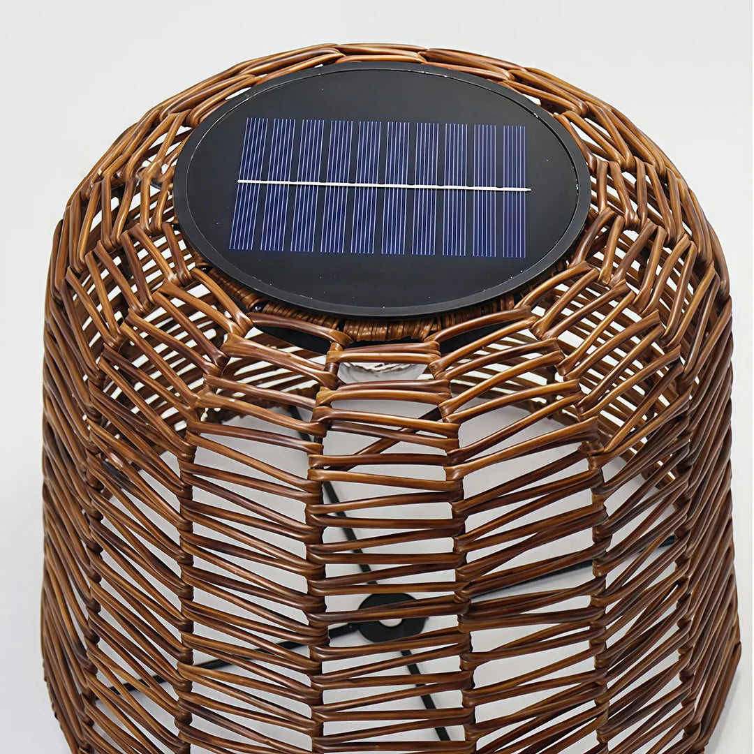 Close-up of a large woven pendant light featuring a built-in solar panel and brown wicker shade.