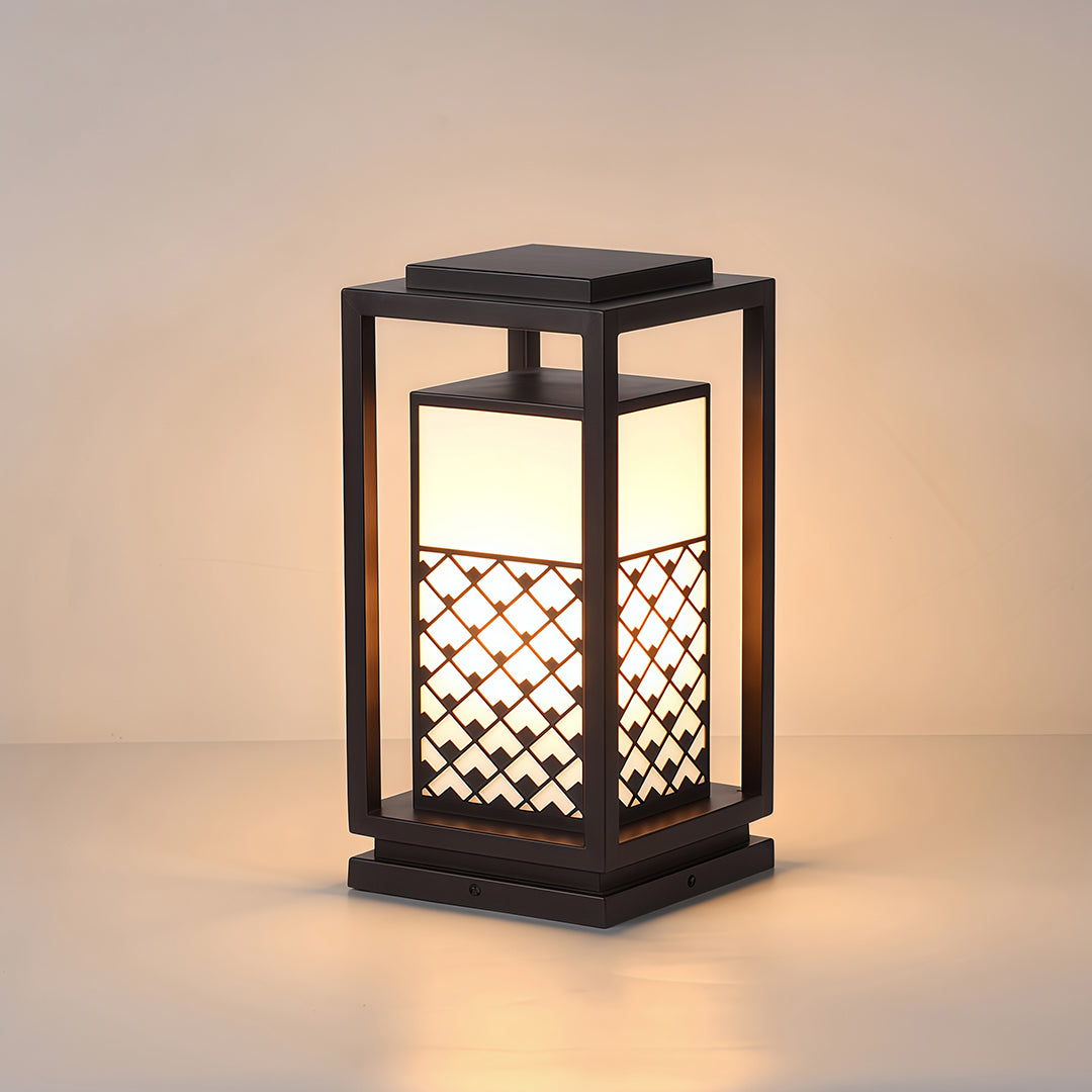 Bollard light fixture with a lattice frame, providing elegant lighting for a garden or outdoor living space.