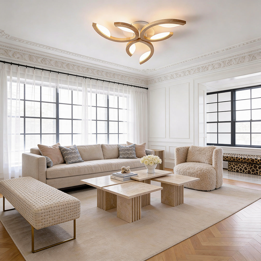 Modern living room styled with a sculptural leaf ceiling light, spreading soft ambient lighting across neutral furniture.