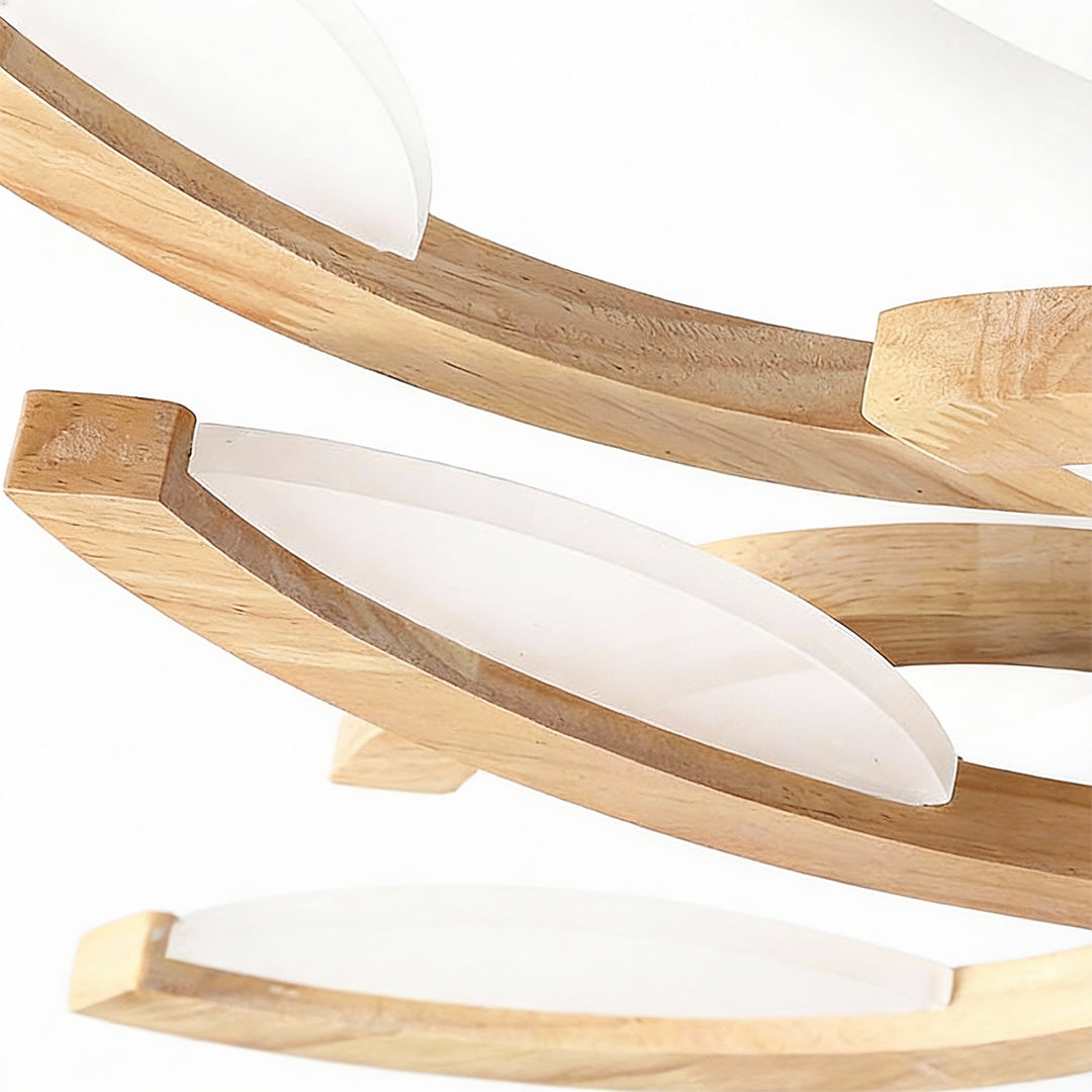 Detailed close-up of wooden-textured arms on a leaf ceiling light, showcasing craftsmanship and soft LED diffusion.