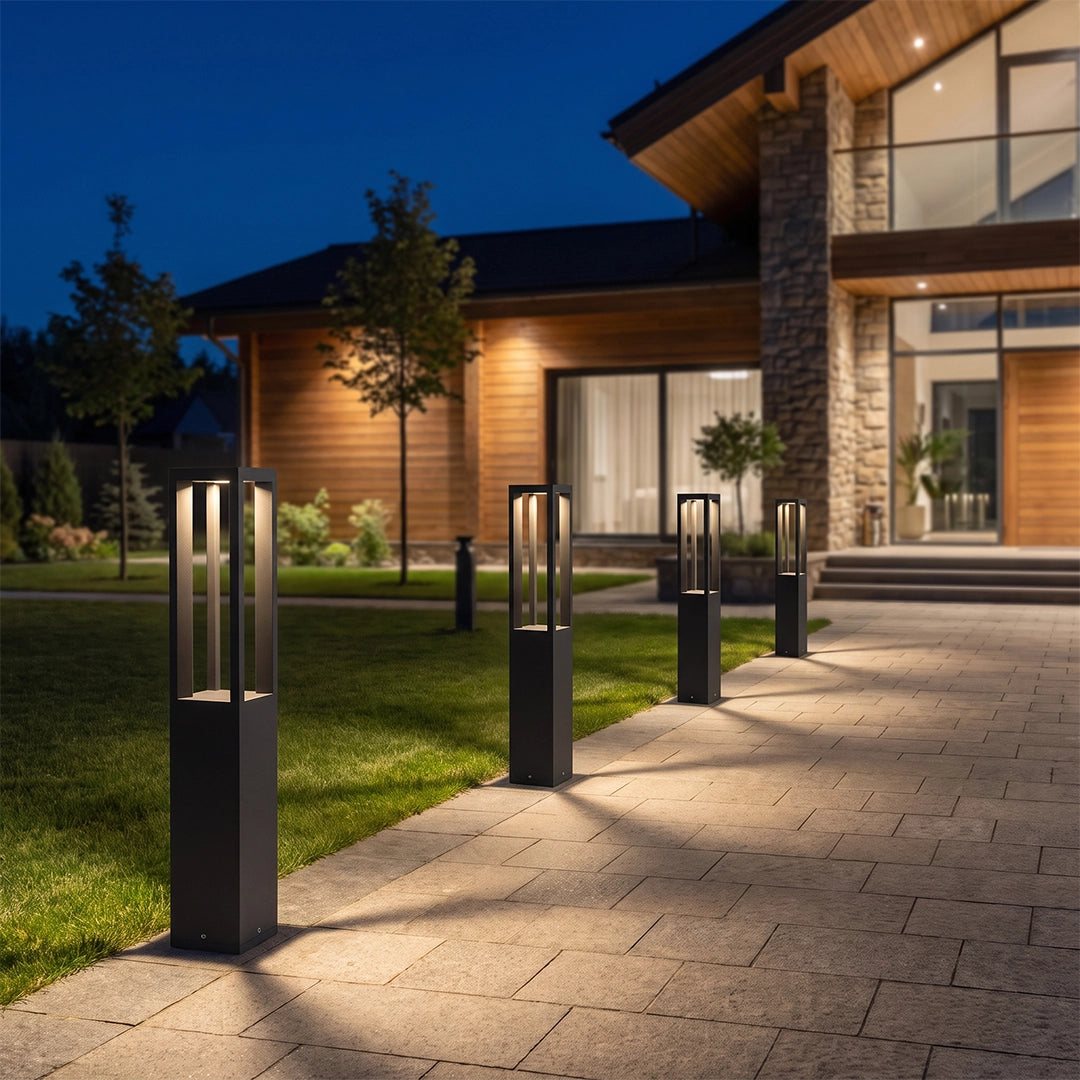 LED bollard garden lights lining a contemporary front walkway and casting warm light along the garden path.