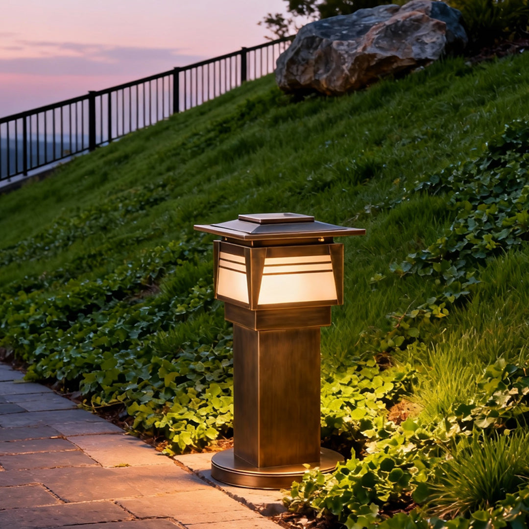 LED bollard garden lights installed on a grassy slope, highlighting landscape contours and improving nighttime visibility.