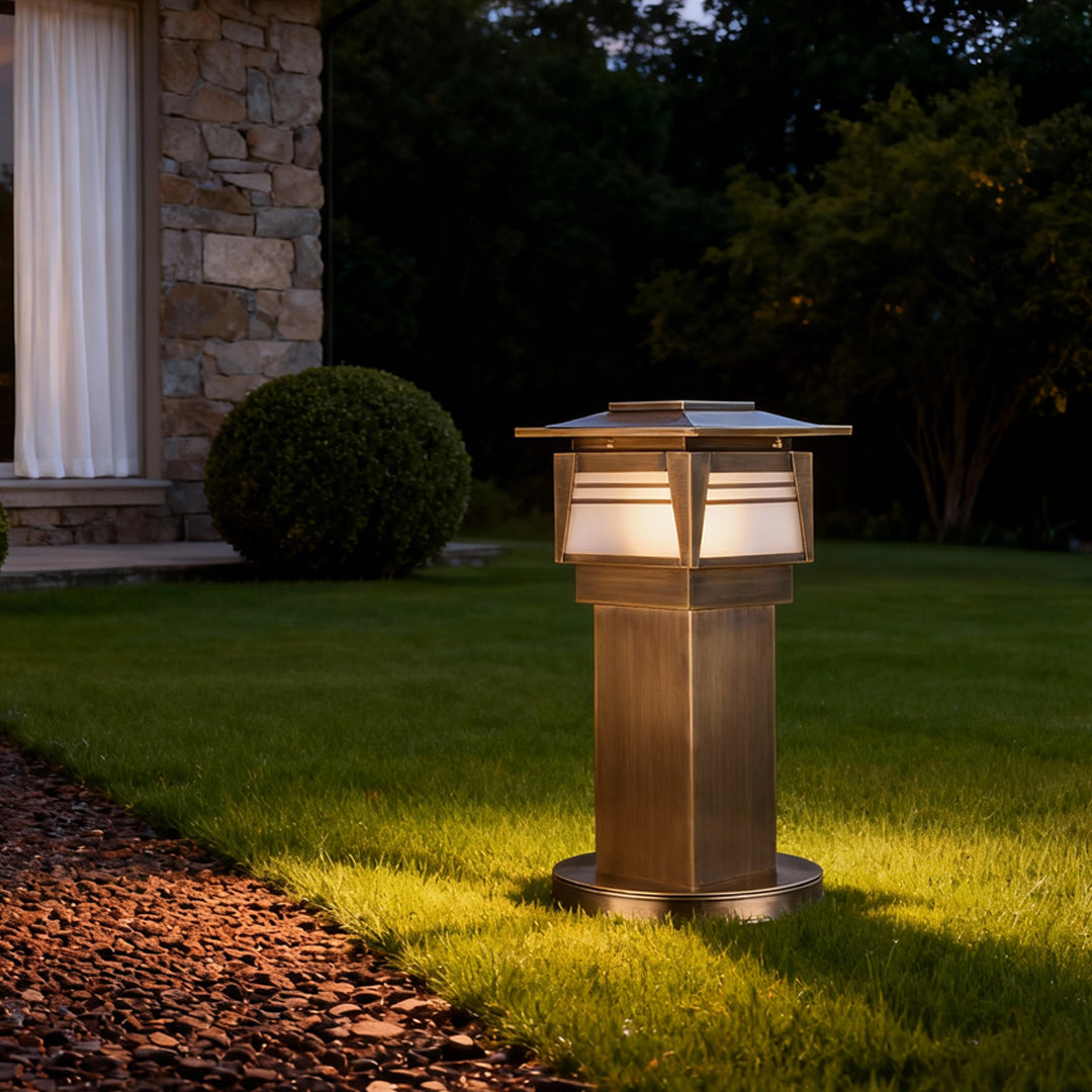 LED bollard garden lights positioned on a lawn near architectural walls, enhancing outdoor safety and visual appeal at night.