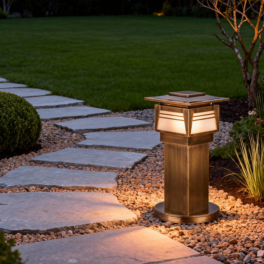 LED bollard garden lights installed along a stone garden path, creating soft guiding illumination for nighttime landscapes.