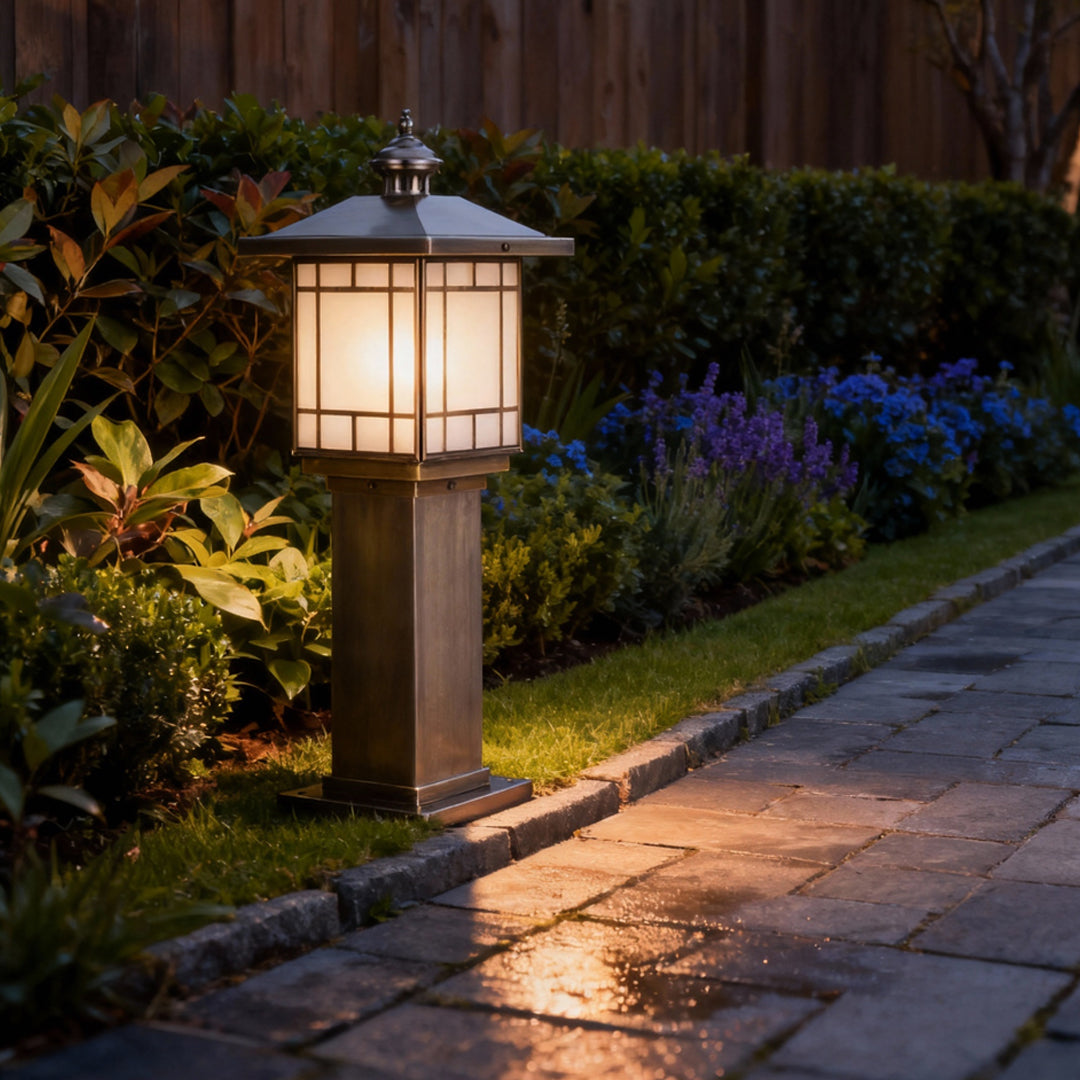 LED bollard landscape lighting lining a paved path near plants, providing balanced illumination and decorative appeal.